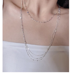 Detail of layered S925 sterling silver lace chain necklace with colorful pendants