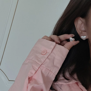 Elegant heart-shaped S925 sterling silver hoop earrings with polished finish on model