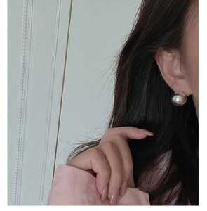 Macro view of 10mm polished S925 sterling silver ball stud earring on a model