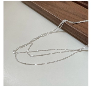 Detail view of S925 sterling silver three-layer lace chain with oval metallic plates