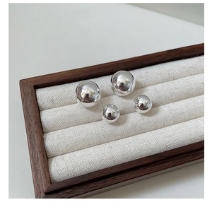 Polished S925 sterling silver ball earrings in two sizes displayed in a premium jewelry box