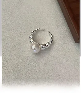 Macro shot of S925 sterling silver croissant ring with a large white pearl detail