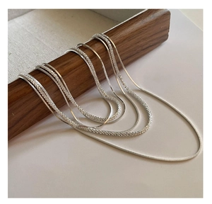 Detail showing various textures of S925 sterling silver snake and twisted rope chains