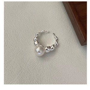 Detail of S925 silver ring with large round pearl and elegant bubble textured band