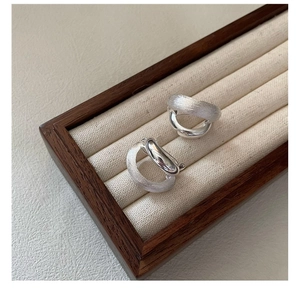 Detail view of 925 sterling silver earrings with matte and polished interlaced rings
