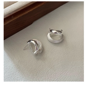 Macro view of 925 silver hoop earrings with dual polished and frosted texture finish