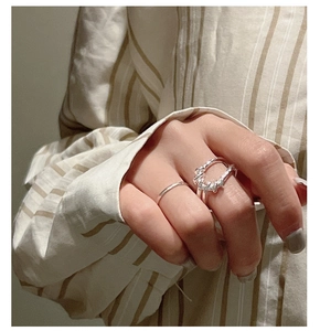 Dettaglio del set di anelli in argento sterling S925 con nodo intrecciato e anello liscio