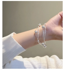 Detail of S925 sterling silver multilayer beaded bracelet on woman's wrist