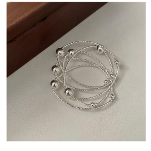 Detailed view of S925 sterling silver multilayer beaded bracelet with woven metal texture