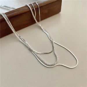 Minimalist S925 silver layered necklace featuring sleek snake and textured chain design
