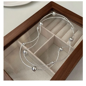 Detail of S925 silver beaded multi-strand bracelet in a wooden jewelry box