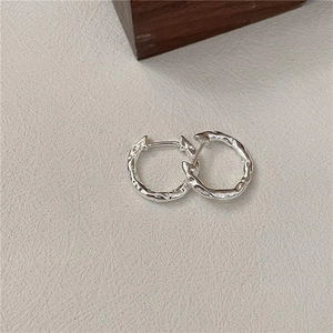 Minimalist S925 sterling silver hoop earrings with irregular hammered lava texture surface