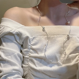 S925 sterling silver multi-layer beaded necklace worn by a model on white clothing