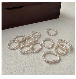 Detail of stacked handmade S925 silver beads and white baroque freshwater pearl rings