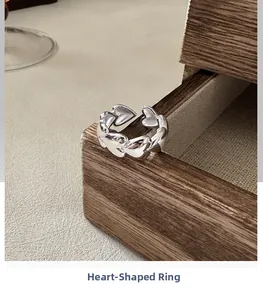 Detailed view of interconnected silver hearts on an adjustable S925 sterling silver ring