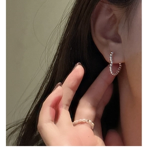 Close-up of S925 silver beaded hoop earrings and elegant pearl beaded ring on model