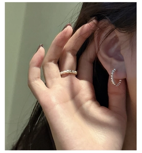 Close-up of minimalist S925 silver beaded ring and matching hoop earring worn by a model