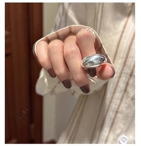 Detailed view of wide minimalist S925 sterling silver ring with high-polished mirror finish