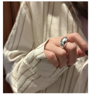 Detail of S925 sterling silver chunky ring with polished surface and pearl accent