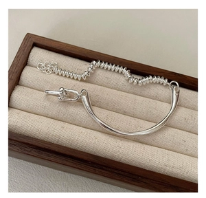 Detailed macro of S925 sterling silver bangle with textured beads and polished metal bar