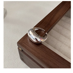 Detailed macro view of S925 sterling silver open ring on wooden jewelry display box