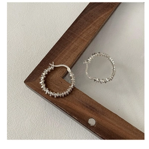 Macro detail of S925 sterling silver stamp on the textured hoop earrings closure