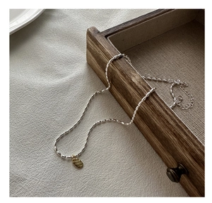 Détail du collier de perles en argent S925 avec pendentif ovale doré gravé LOVE