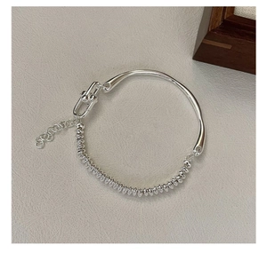 Macro detail of S925 silver bracelet featuring smooth band and bead chain with U-shaped link