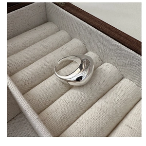 Polished S925 sterling silver adjustable ring displayed in a luxury beige jewelry box