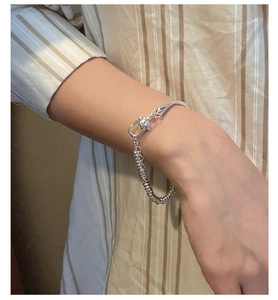 Macro detail of S925 sterling silver abacus bead bracelet with horseshoe clasp on wrist
