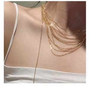 Detail of layered gold S925 silver necklaces with elegant shimmering fringe chains