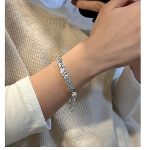 Macro view of S925 sterling silver bracelet showing unique hammered texture and adjustable clasp