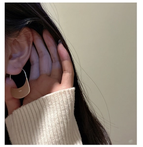 Detail of S925 sterling silver half-moon dangle earring worn on model for a chic look