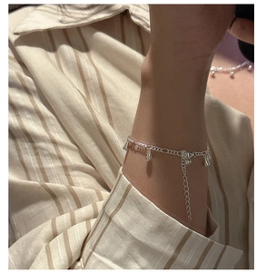 Detail of silver water-drop tassel bracelet with adjustable chain on wrist