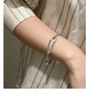 Macro shot of silver geometric minimalist bracelet with U-shaped link design