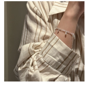 Close-up of S925 sterling silver water drop tassel bracelet on a female model wrist