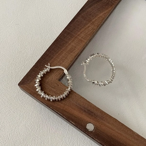 Minimalist S925 sterling silver hoop earrings featuring textured silver nugget design