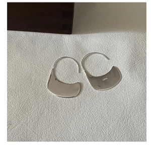Close-up of S925 sterling silver stamp on minimalist streamlined hook earrings