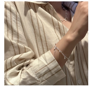 Detail of S925 sterling silver bracelet and necklace with water drop fringe charms