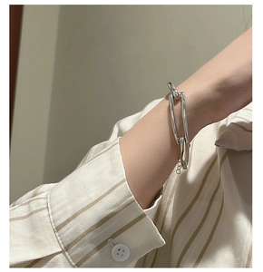 Detail of S925 sterling silver geometric link bracelet worn on a female wrist