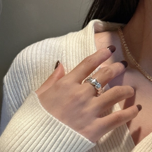 Minimalist S925 sterling silver twisted knot ring on finger showing modern texture