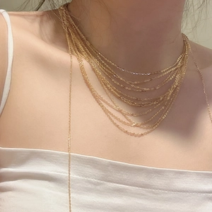 Minimalist multi-layer gold S925 sterling silver tassel necklace shown worn on a neck