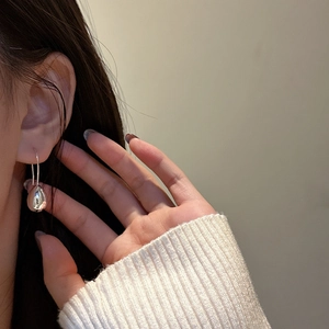 Minimalist S925 sterling silver teardrop earrings on model with polished finish