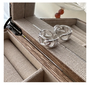 Macro view of S925 sterling silver chain link ring on a linen jewelry display box