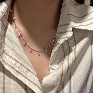 Minimalist S925 sterling silver necklace with stylish water drop charms on a female model