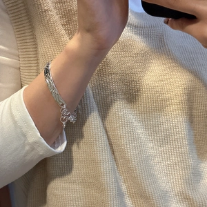 S925 sterling silver liquid metal cuff bracelet with irregular lava texture on wrist