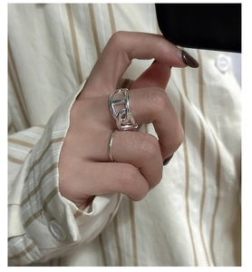 Close-up of S925 silver pig nose anchor link ring and minimalist slim band on finger