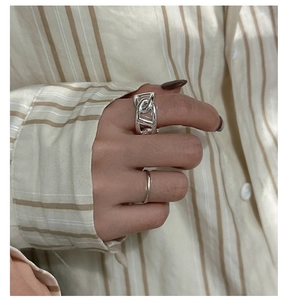 Detail of silver S925 sterling silver pig nose chain rings set on model's hand