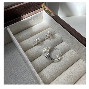 Three elegant S925 sterling silver adjustable rings with white round pearls in a wooden box