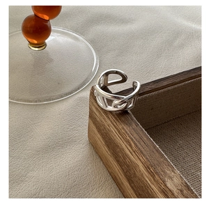Detail of silver pig nose anchor chain ring on a wooden jewelry display stand